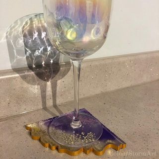 single purple and gold rock geode coaster with wine glass on
