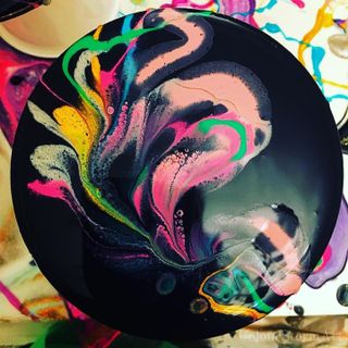 circular coaster - dark with white, yellow, pink, green swirls